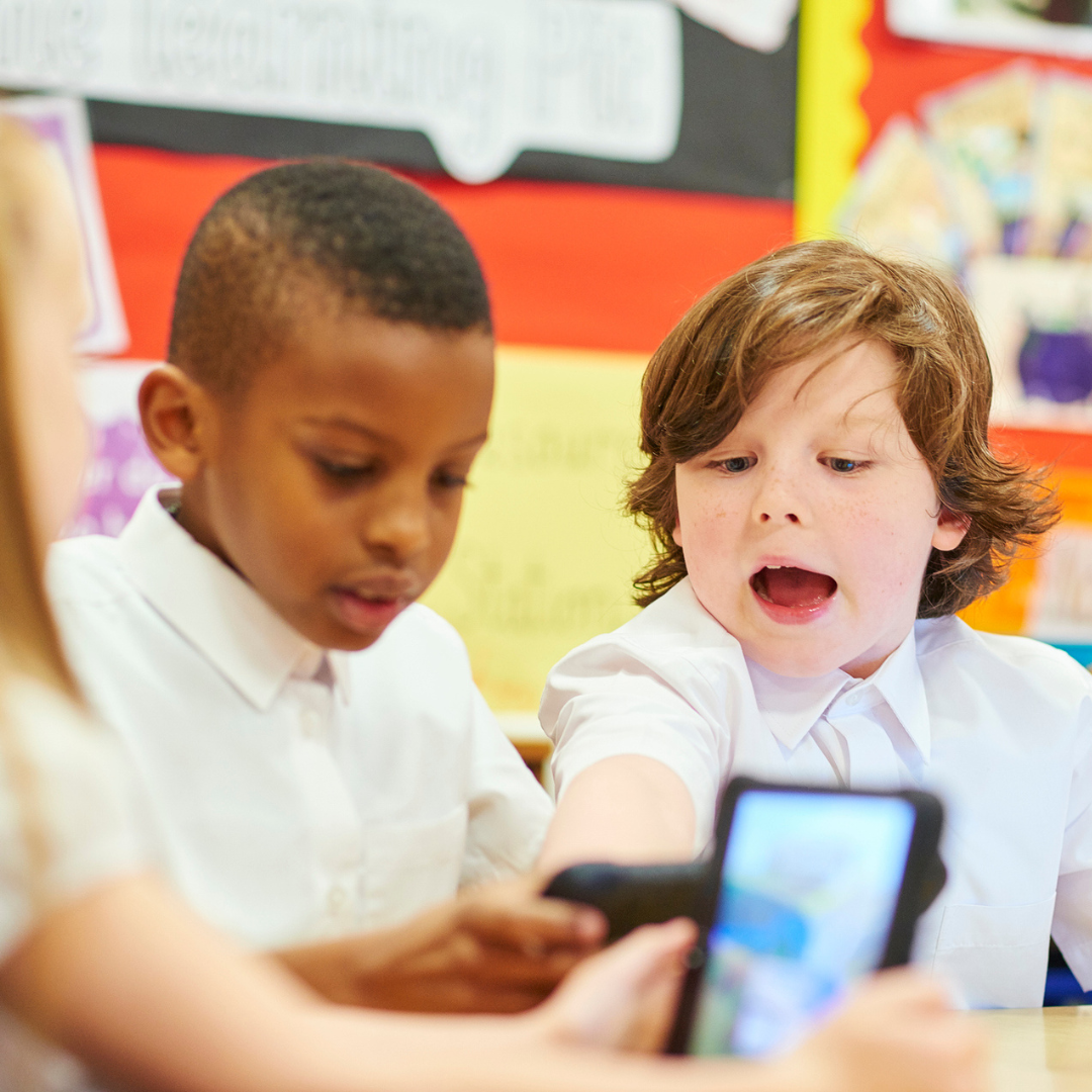 Pupils in classroom looking at iPads
